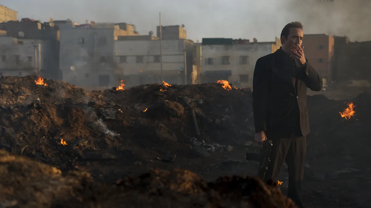 Nicolas Cage en Yuri Orlov devant des décombres en feu, photo officielle de Lords of War